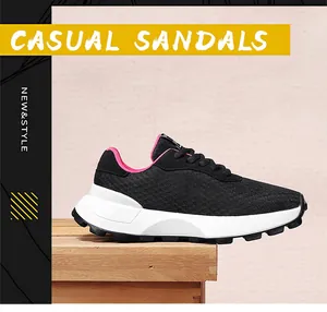 Detailed shot of black breathable mesh sneakers with pink lining on wooden base