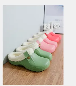 Row of colorful winter clogs featuring soft white fleece lining on wooden surface