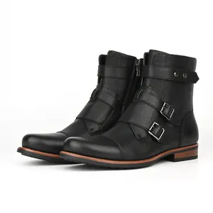 Detailed view of men's vintage black boots with silver buckles and side zipper