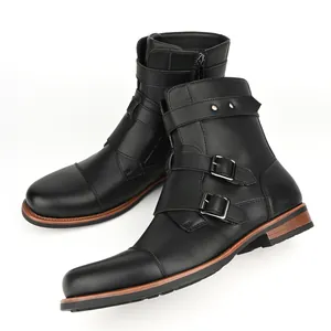 Detailed side view of men's retro black leather boots with metal buckles and side zippers