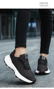 Close-up of black breathable mesh sneakers for teenagers worn in an urban outdoor setting