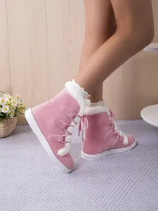 Pink winter snow boots for women with cozy faux fur lining and lace-up detail.