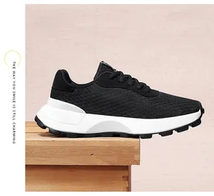 Detailed side view of black breathable mesh sneaker with thick white platform sole