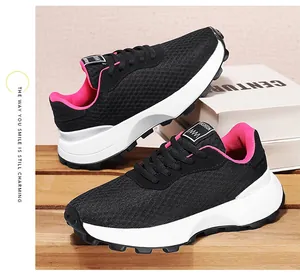 Detailed view of black breathable mesh sneakers featuring pink interior and chunky white soles