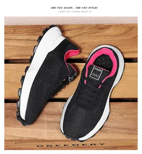 Detailed view of breathable black mesh athletic sneakers with vibrant pink lining.