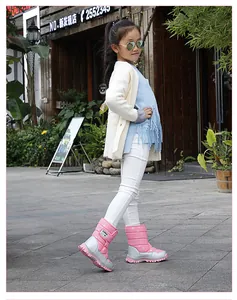 Asian child model wearing pink and silver snow boots for winter outdoor activities