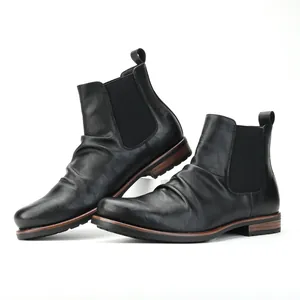 Side detail view of black men's pleated Chelsea boots featuring elastic side panels