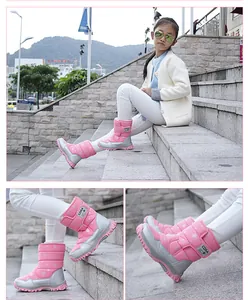 Detailed view of pink children's winter snow boots with warm lining and snowflake patterns