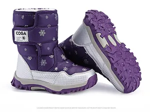 Detailed view of children's purple snowflake snow boots showing non-slip sole texture