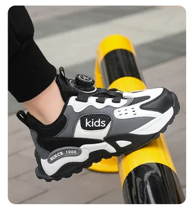 Close-up of durable children's sneaker with rotary buckle and black white grey design