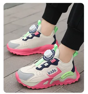 Detail shot of kids' pink and beige sneakers with rotary dial closure on pavement.