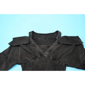 Detail of a washed distressed black sexy off-shoulder tight jumpsuit collar design.