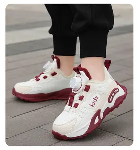 Detail view of kids winter sneakers with white leather surface and burgundy accents