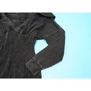 Detailed view of a vintage washed black ribbed jumpsuit featuring a gathered V-neckline.