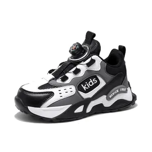 Children's winter sports sneaker in black and white with a rotating knob buckle closure