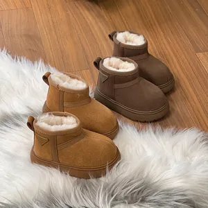 Warm children's snow boots with plush faux fur lining in tan and dark brown colors.