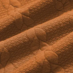 Μακρο φωτογραφία πορτοκαλί βαρέος υφάσματος ζακάρ με λεπτομερή υφή διαμαντιού