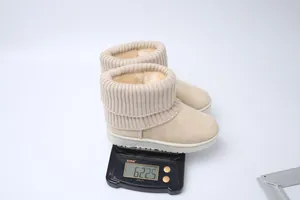 Close-up of beige platform snow boots with knitted cuffs weighing 622.5g on a scale