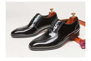 Elegant black patent leather Oxford shoes with brogue details for formal wedding