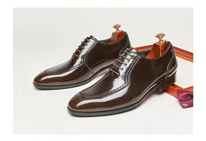 Polished brown patent leather Oxford shoes with vintage square toe and brogue details