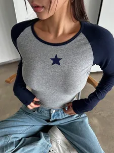 Close-up of a slim-fit grey and navy raglan long-sleeve T-shirt featuring a star print detail