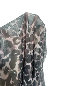 Detailed view of leopard print mesh fabric showing sheer texture for women's tops