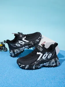Side view of black breathable mesh boys running shoes with chunky camouflage sole