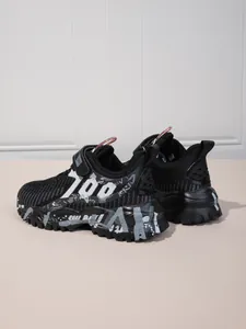 Detailed side view of boys' black breathable mesh sneakers with graffiti pattern