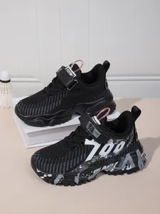 Close-up detail of black breathable mesh kids' running shoes with stylish 700 graphic print