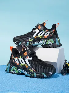 Side profile of breathable mesh sneakers for boys featuring vibrant graffiti prints and chunky soles.
