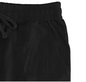 Close-up detail of men's black cotton linen pants featuring elastic waistband and drawstring