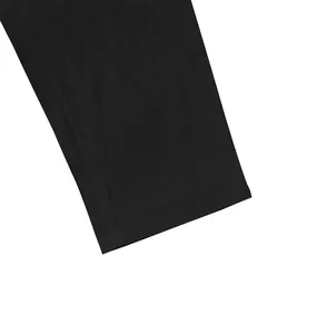 Close-up detail showing the flat hem and precision stitching on men's black cotton linen trousers