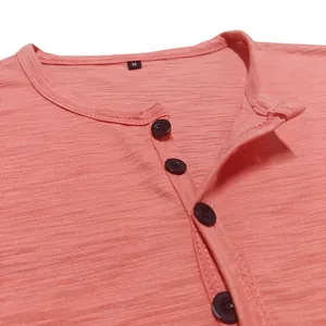 Close-up detail of pink men's Henley shirt showing slub cotton texture and black buttons