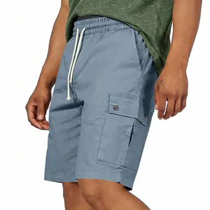 Side pocket detail on men's dusty blue drawstring cargo shorts for summer wear.