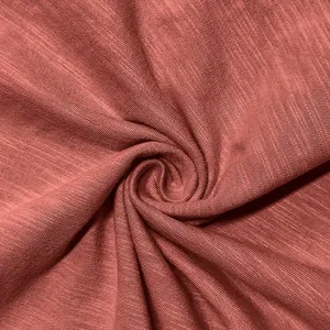 Detailed macro view of reddish-brown slub knit fabric for casual men's Henley shirt