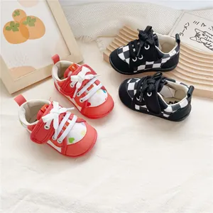 Macro detail of soft sole baby walking shoes featuring cute heart and checkerboard patterns