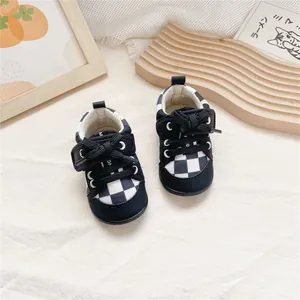 Top view of checkered baby walking shoes with soft soles and heart-shaped Velcro straps