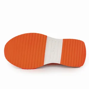 Close-up of the orange and white anti-slip sole with textured grip for sport shoes