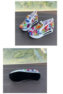 Detalle de zapatos slip-on de malla bordada con estampado paisley y plataforma