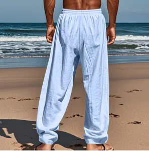 Back view of light blue men's cotton linen casual beach pants in sunny setting