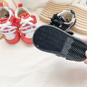 Close-up of the anti-slip wavy rubber sole on soft baby walking shoes for safety.