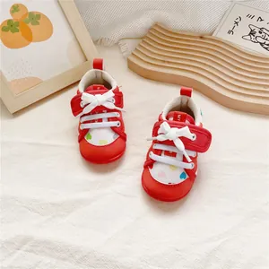 Red soft-sole baby walking shoes featuring cute heart patterns and easy velcro straps.