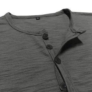 Close-up detail of grey men's short-sleeve Henley shirt showing collar and buttons
