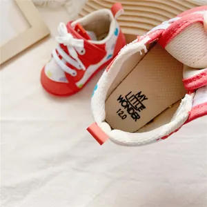 Detailed view of the soft insole of a red heart-patterned baby walking shoe, size 12.0