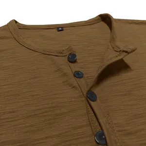 Close-up of brown Henley shirt showing button placket and slub cotton texture details