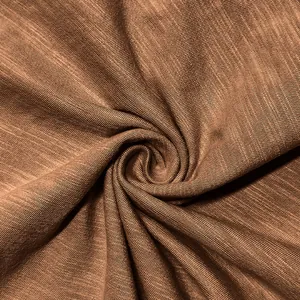 Close-up macro view of soft breathable brown knit fabric texture for men's Henley shirt