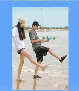 Lifestyle view of quick-dry water shoes for men and women on a sunny sandy beach