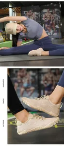 Close-up of beige water shoes with wave patterns in gym setting