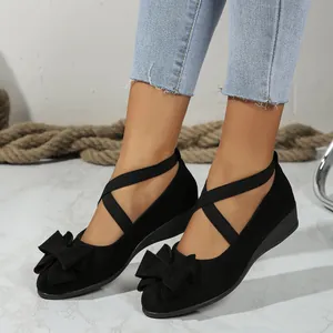 Elegant black suede wedge shoes for women featuring bow detail and elastic cross straps