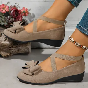 Elegant women's tan suede wedge shoes with decorative bow-knot and elastic straps